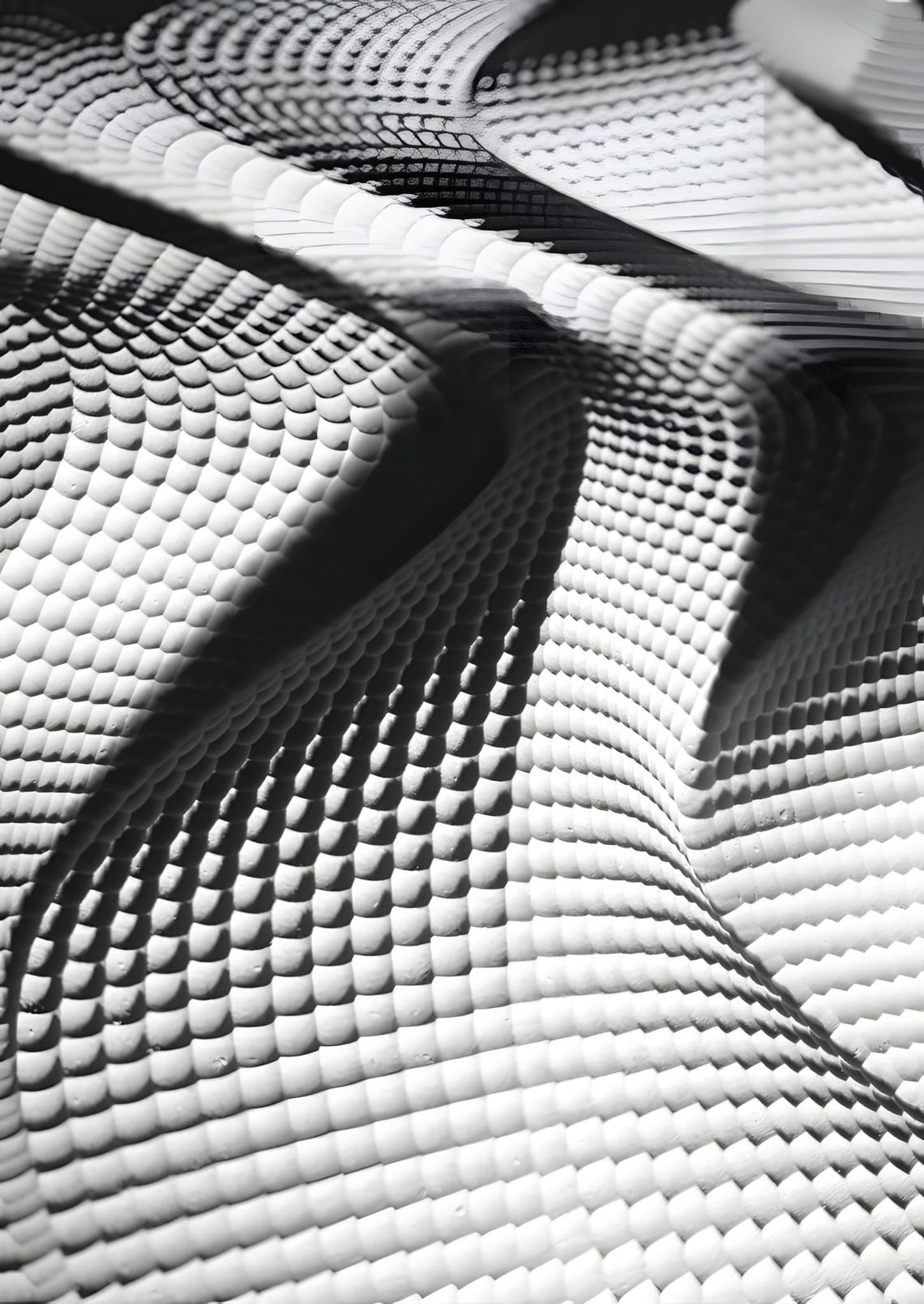 Close-up of a CNC-milled white panel with a regular dome texture, curving in undulating waves. YSOA Advanced Mill Workshop, A