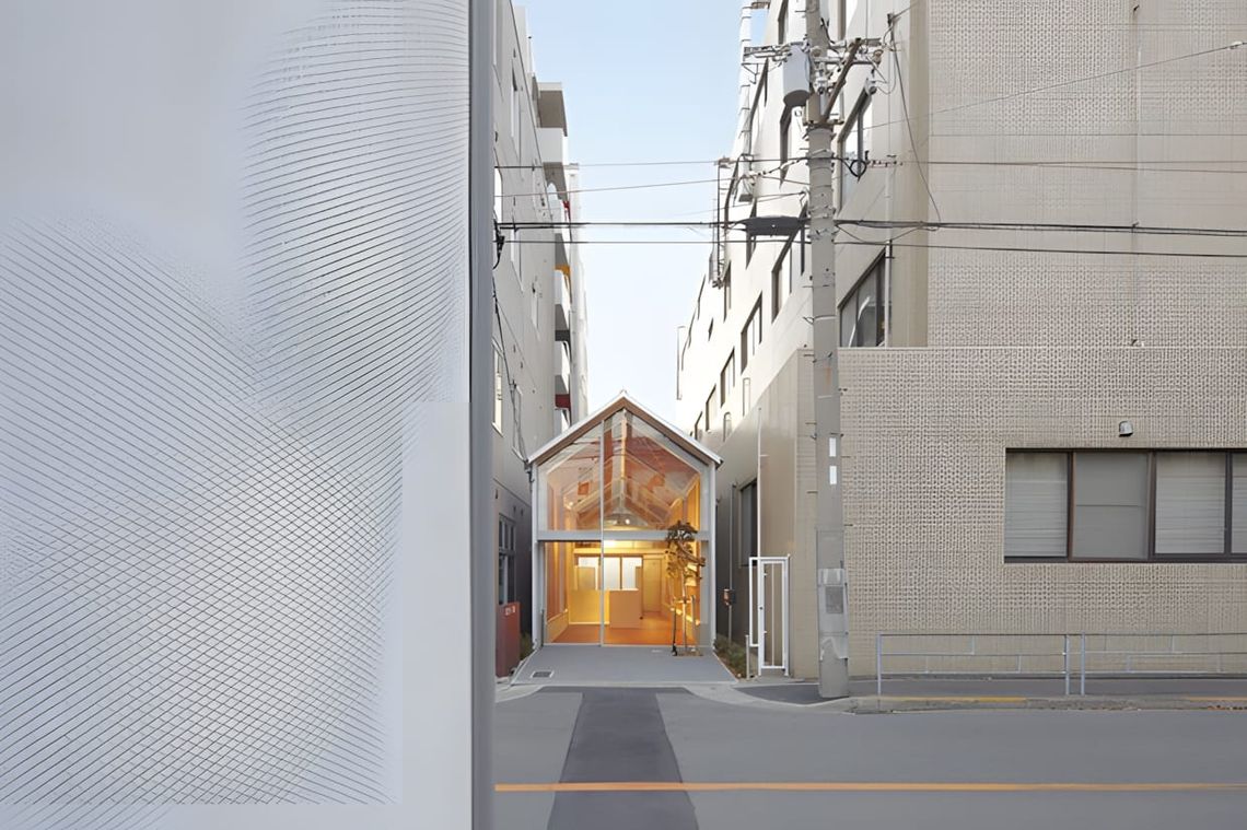 Exterior view of the Ogimachi Global Dispensing Pharmacy in Osaka, a narrow gabled building with exposed wood structural elem