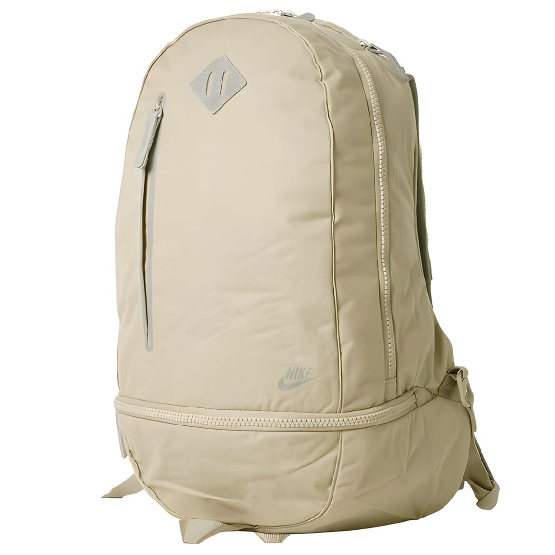 Tan Nike Cheyenne nylon backpack shown front-facing on white background, with tonal Swoosh and NIKE wordmark low on the front
