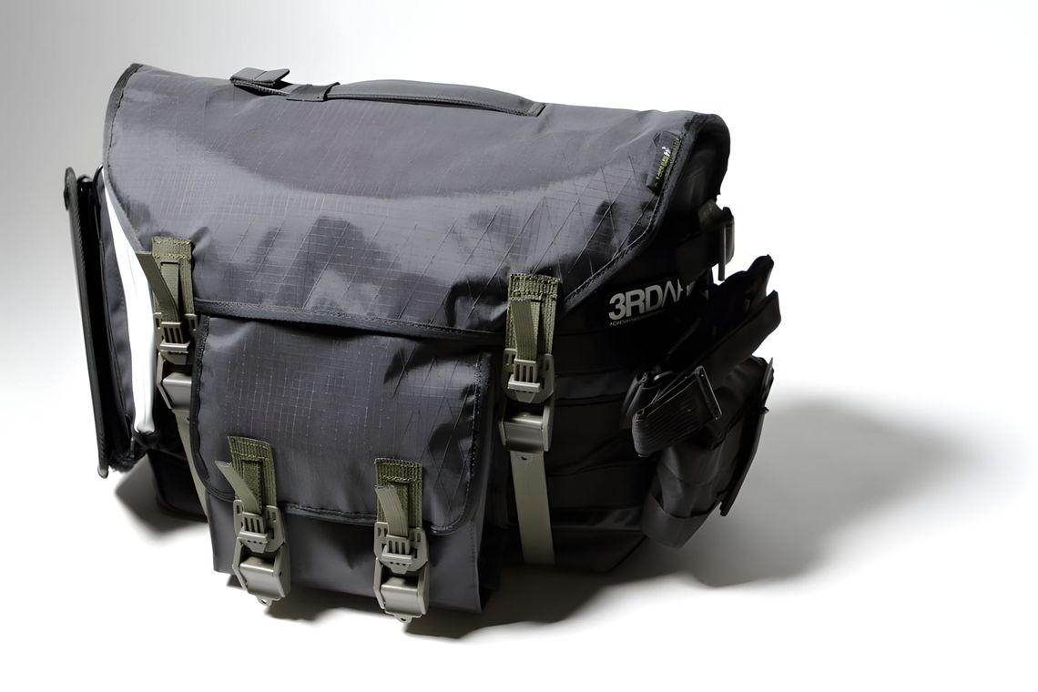 ACRONYM 3A-3TS Third Arm messenger bag in grey ripstop with olive webbing straps and modular front pockets.