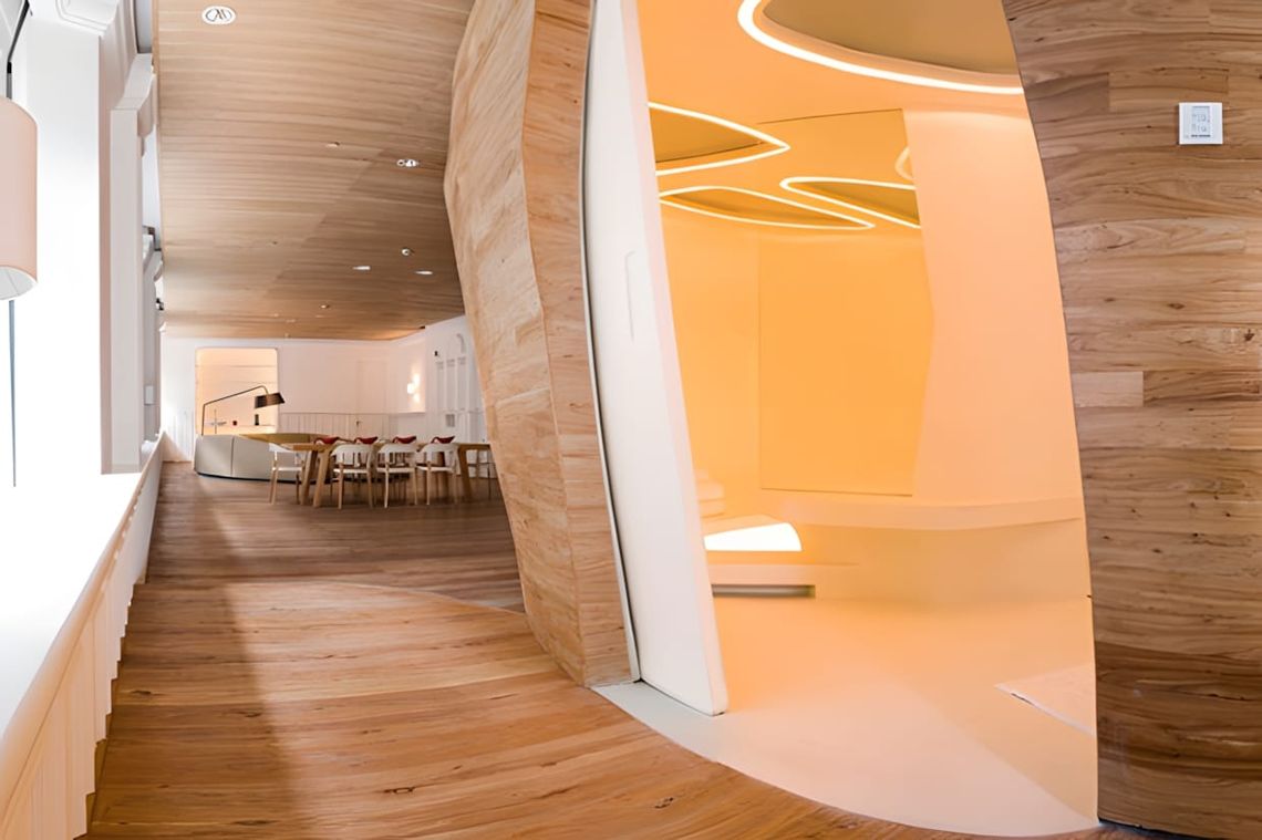 Long corridor in the Swatch Art Peace Hotel, Shanghai: natural wood strip flooring and ceiling cladding, a large organic biom