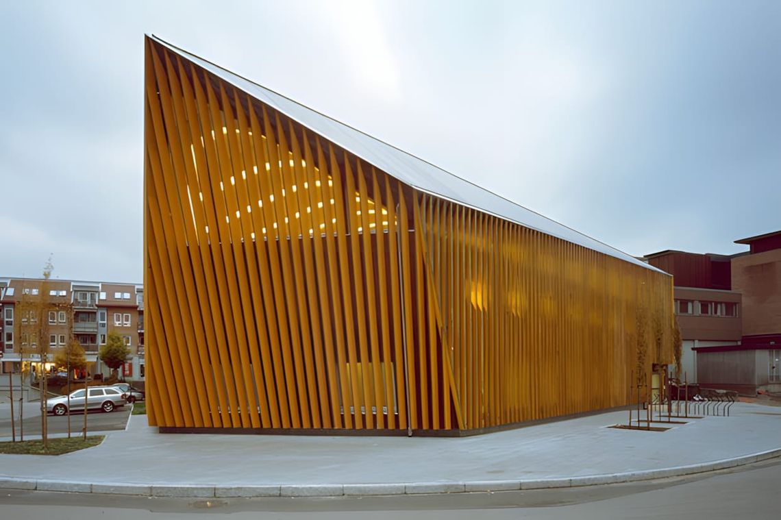 Interior of the Vennesla Library and Culture House, Norway, showing the continuous glue-laminated timber rib-vault with integ