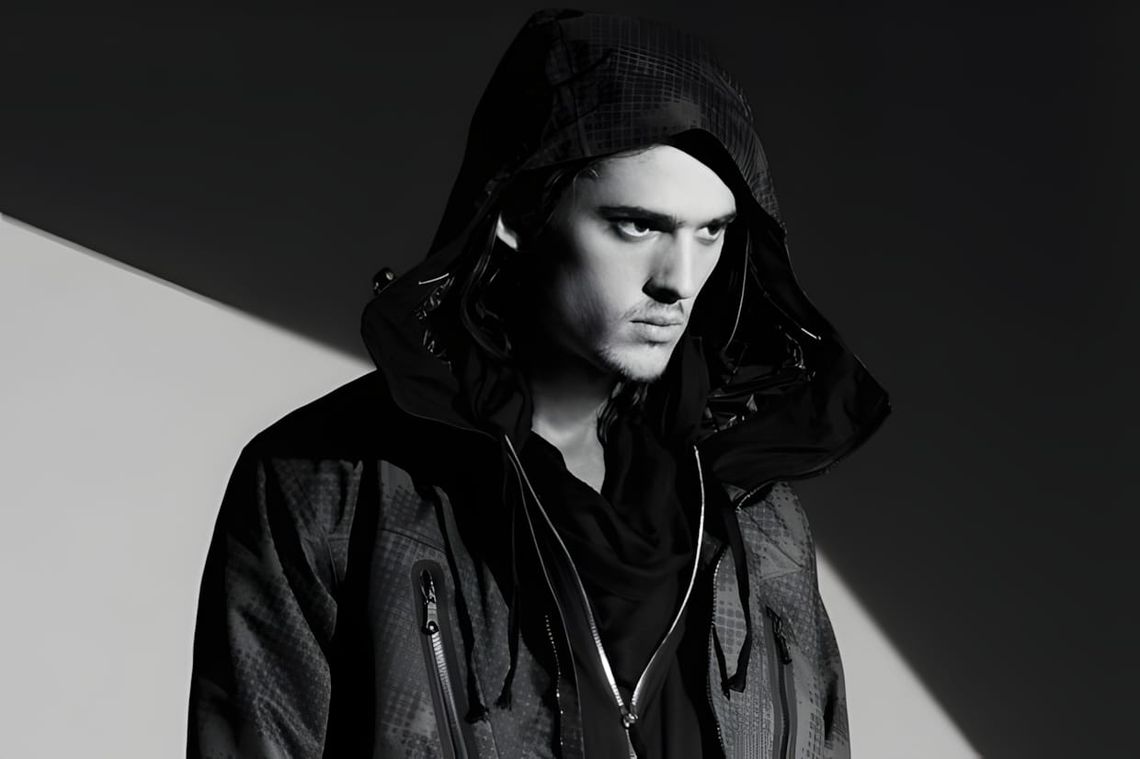 Male model in ISAORA FW2010 hooded grid-quilted technical jacket, B&W lookbook editorial shot.