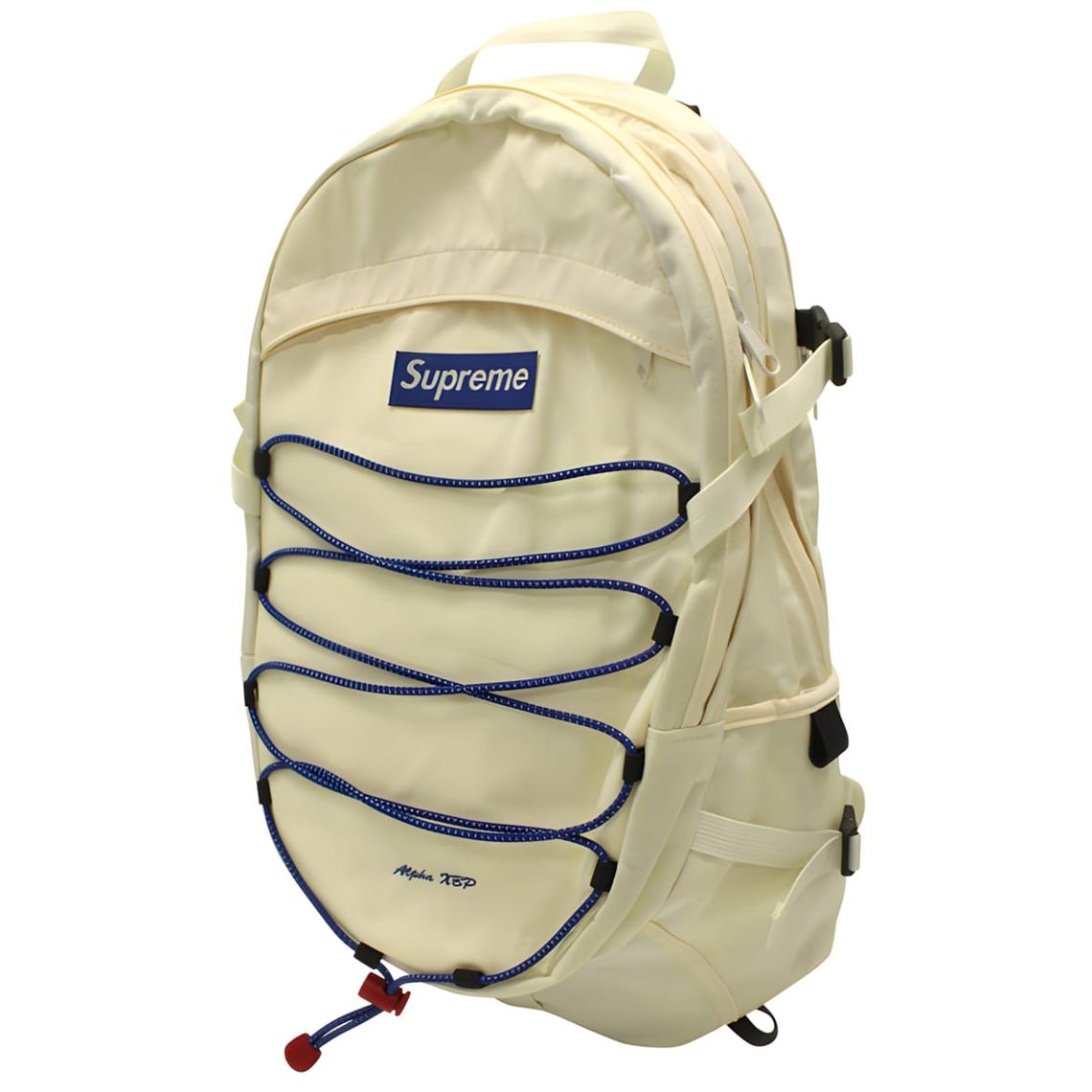 Supreme 18th Alpha XBP backpack in cream/natural nylon with blue bungee cords and embroidered box logo label.