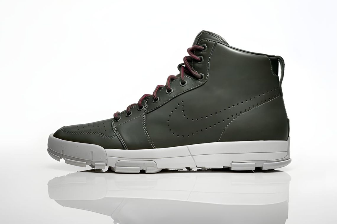 Nike Air Royaltna Mid QS sneaker in a dark colorway, showing the Air Royal upper silhouette over an Air Ratna-derived lug sol