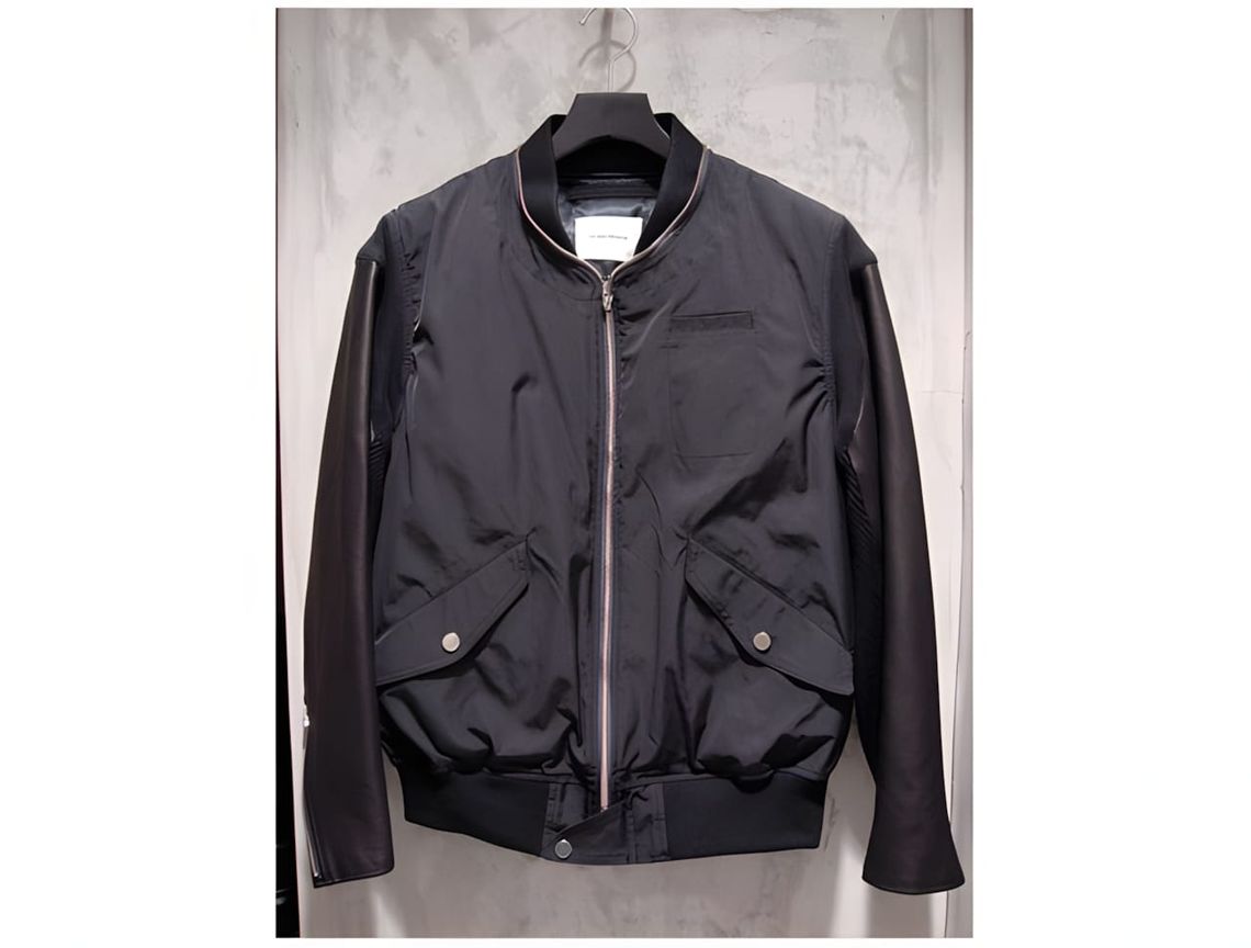 Undercover AW11 'Mirror' MA-1 bomber jacket — olive/green padded nylon body with black cowhide leather sleeves, knit wool sle
