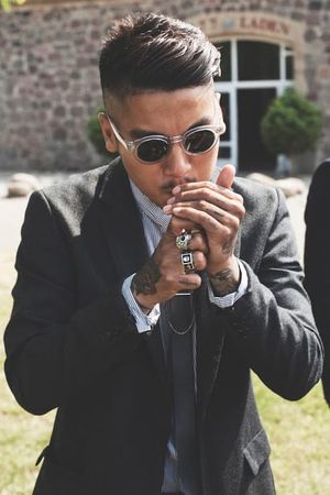 Tattooed Man Lighting a Cigarette