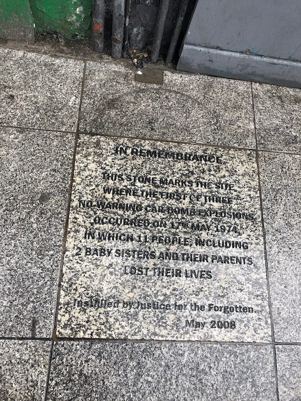 IN REMEMBRANCE: This stone marks the spot where the first of three no warning car bomb explosions occurred on 17th May 1974, in which 11 people, including 2 baby sisters and their parents lost their lives. installed by Justice for the Forgotten, May 2008