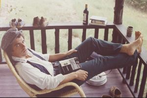 Frank Stanford reading on the porch with his shoes off
