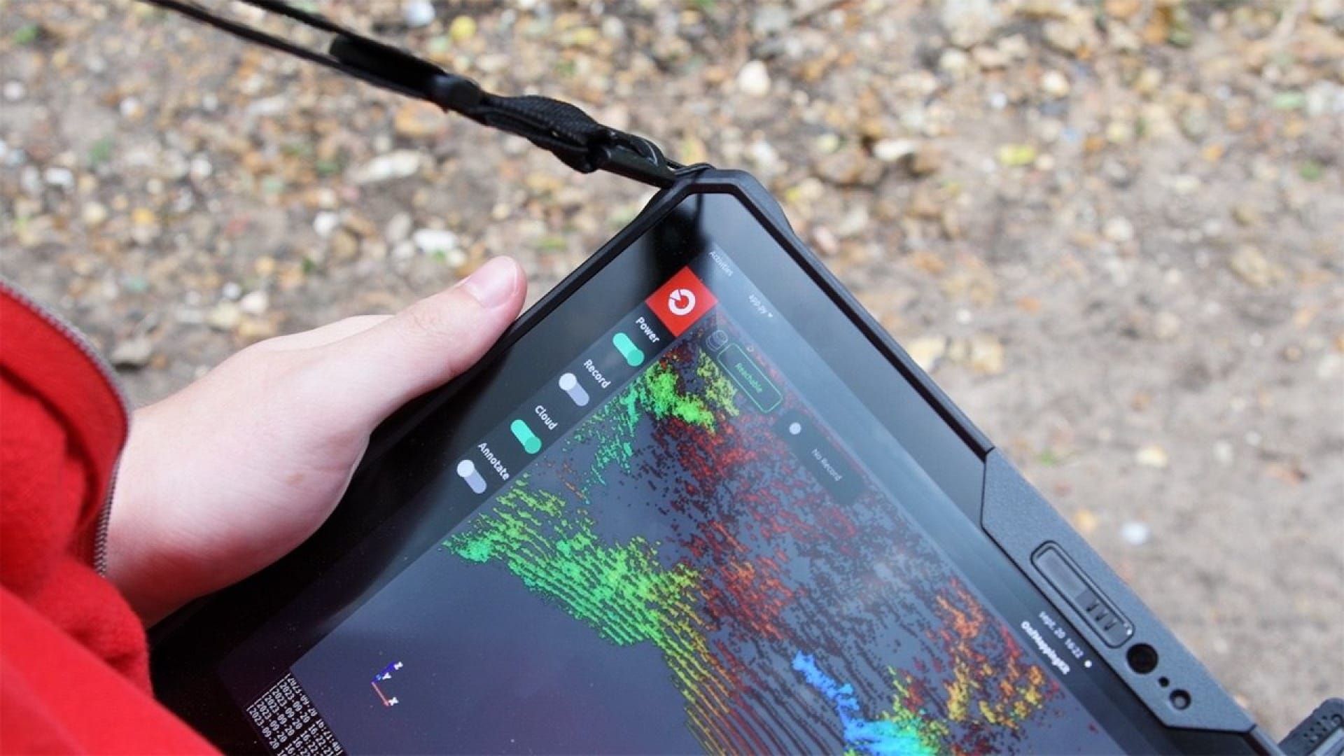 Hand holding a portable device displaying 3D lidar mapping data for smart, on-the-go surveying