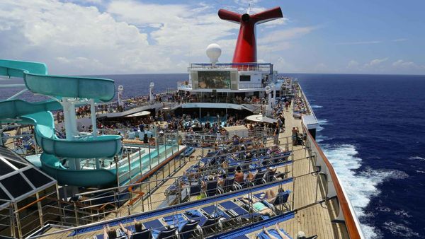 Cruise ship top view with passengers moving across multiple decks.
