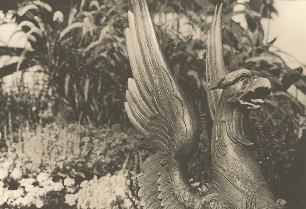 Black and white photo of a bronze gryphon statue.
