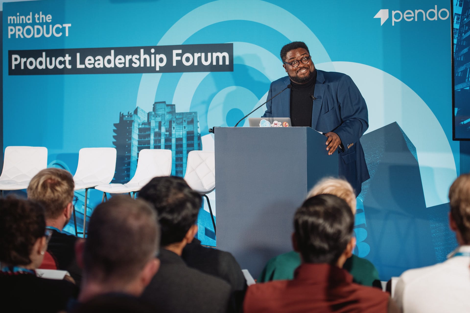 A full room listening at the Product Leadership Forum, London, with the Mind the Product backdrop legible behind the lectern