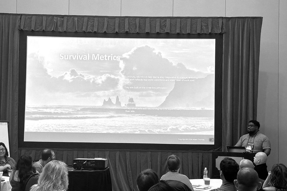 Adam Thomas presenting Survival Metrics to a conference room of product leaders