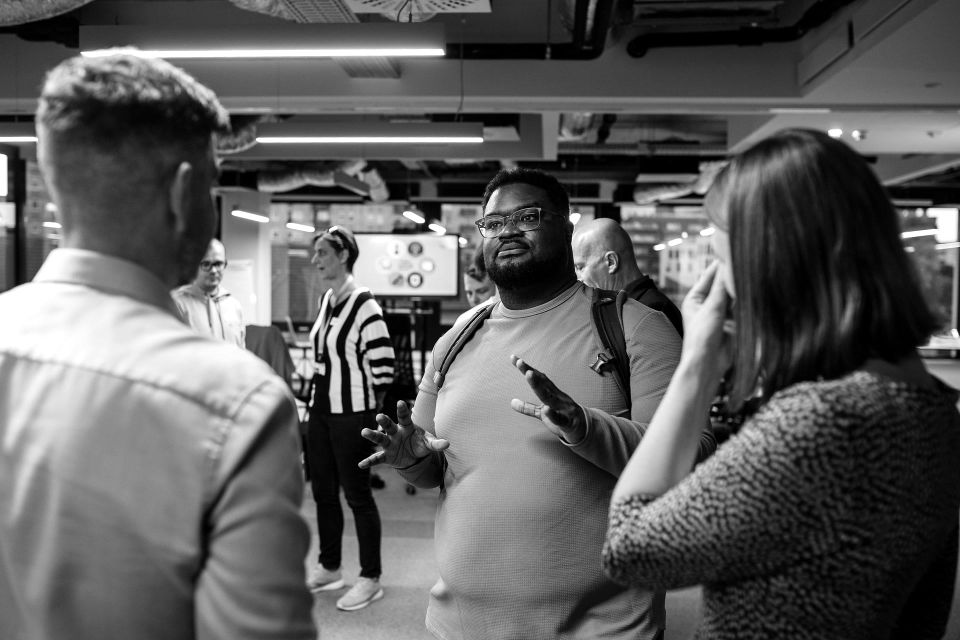 Adam Thomas answering two workshop attendees mid-conversation