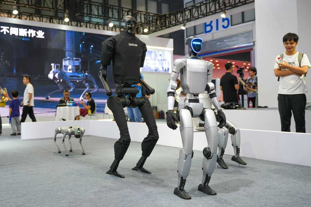 Unitree G1 and H1 humanoid robots standing side by side, both with stub arms and no articulated hands