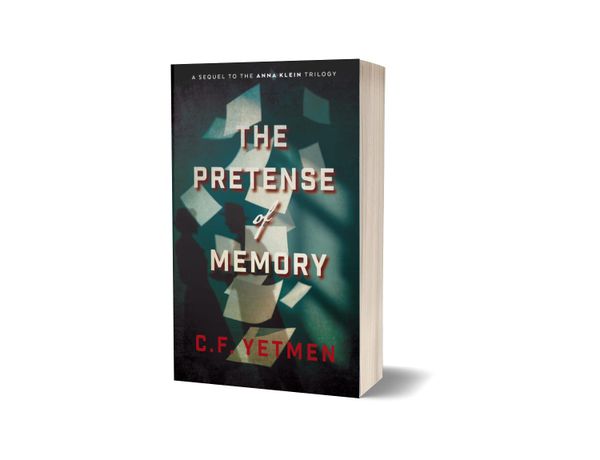The cover of The Pretense of Memory showing two shadowy figures and a flurry of fallin papers against a dark backdrop