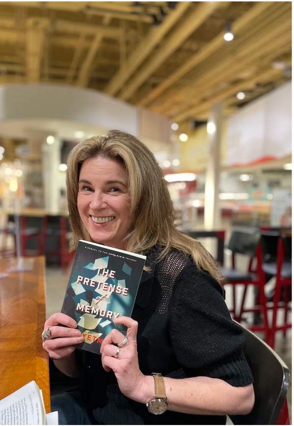 Canan with a copy of The PRetense of Memory