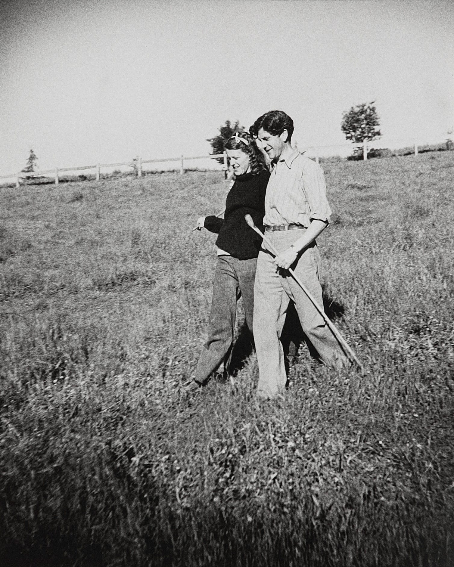 Sunday and John Reed 1943, Heide Museum of Modern Art. Photography by Albert Tucker, gift of Barbara Tucker 2001. Young couple walking on gras monochrome photography.