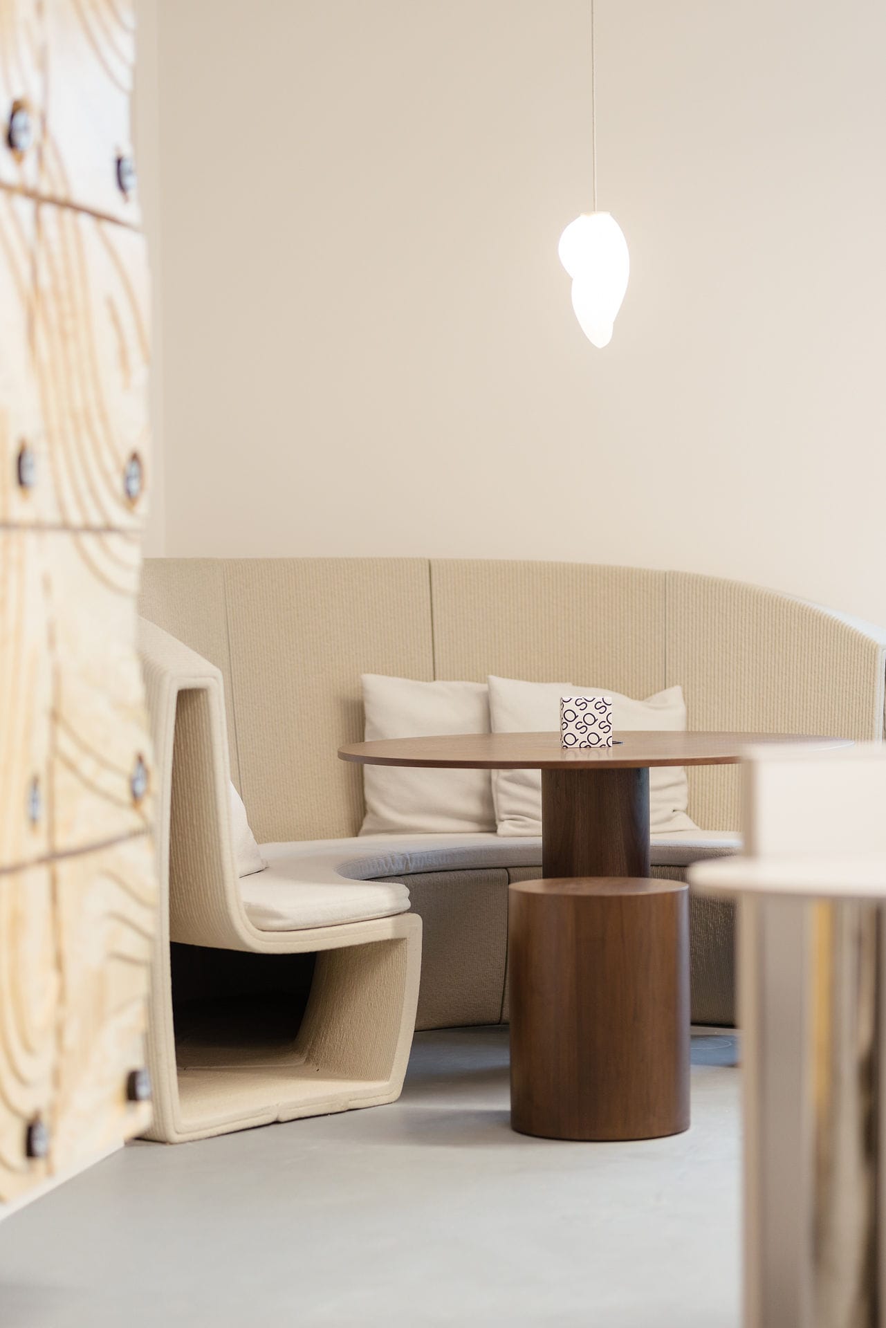 Silversquare Co-Working Space by Lilian van Daal. Photography by Save as Studio. 3D printed, fitted, sand colored office furniture and dark wooden round table with stools.