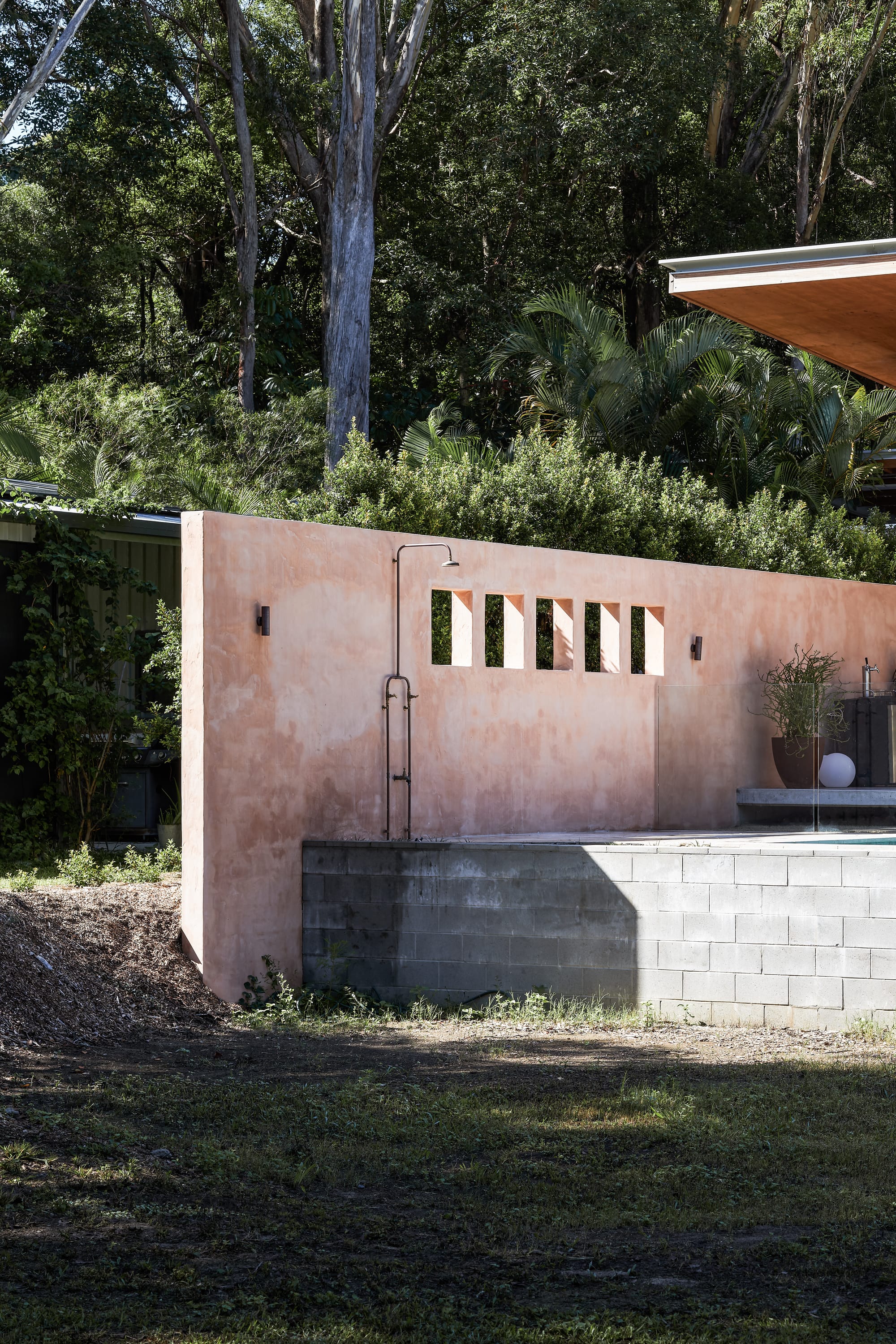 Outside view on terracotta wall with shower.