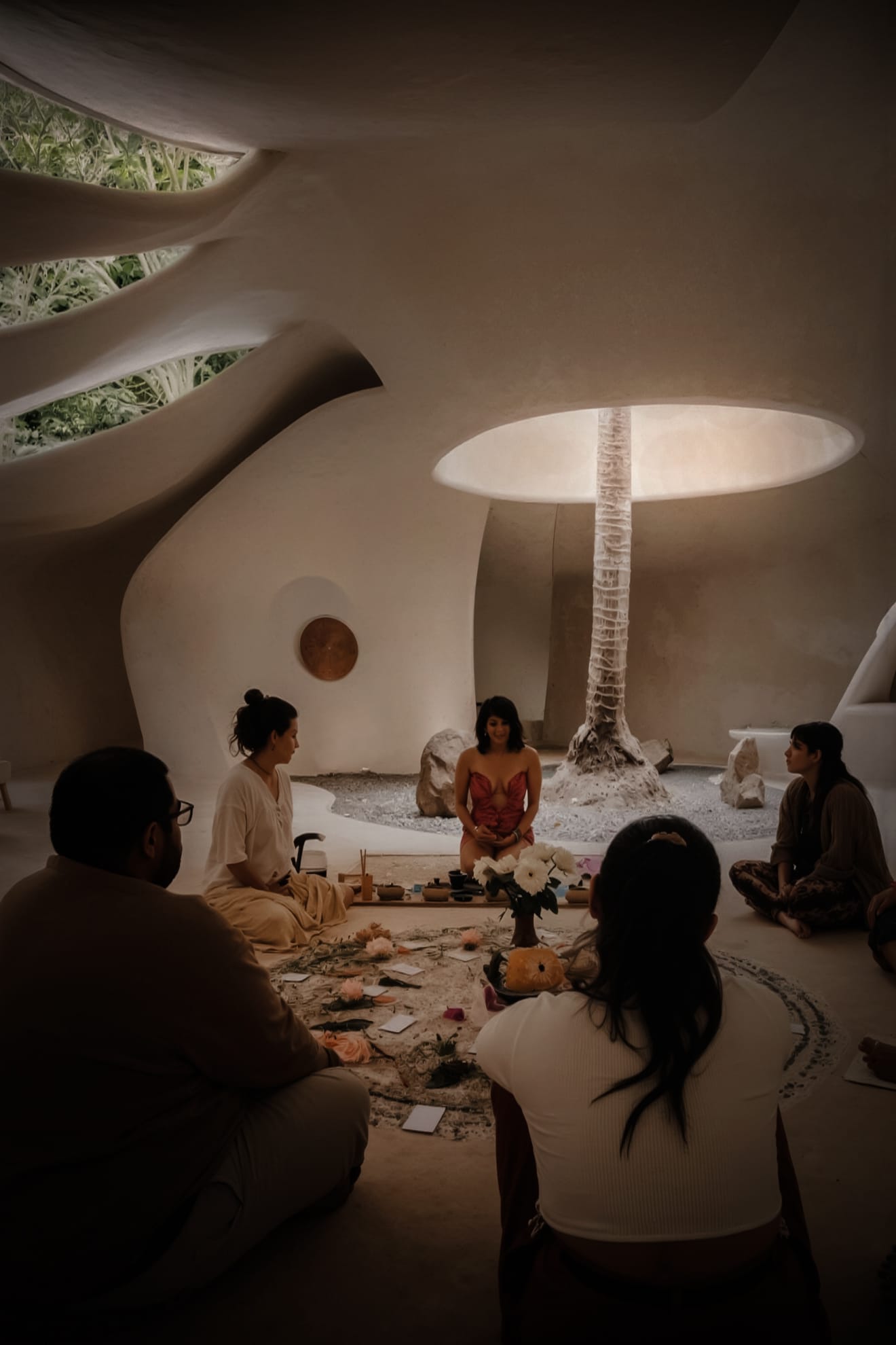 Holistic healing center with organic architecture and spiritual circle of people gathering.
