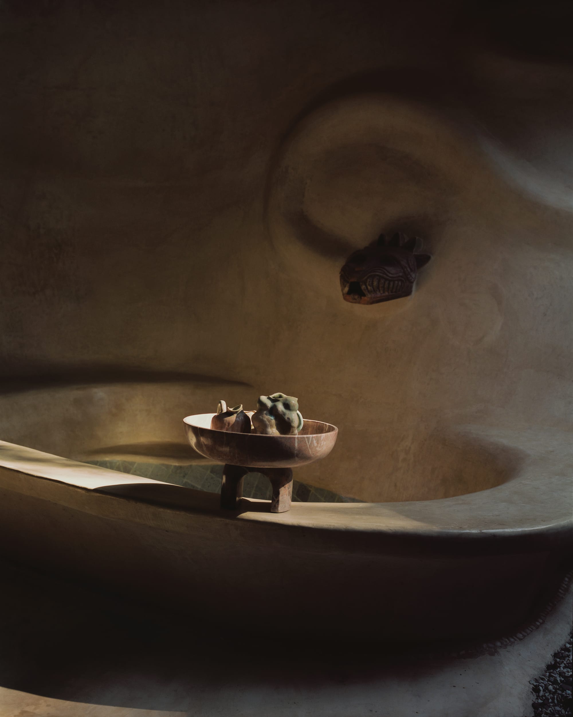 Organically shaped, seamless bathtub with beautiful natural light and snake shaped faucet.