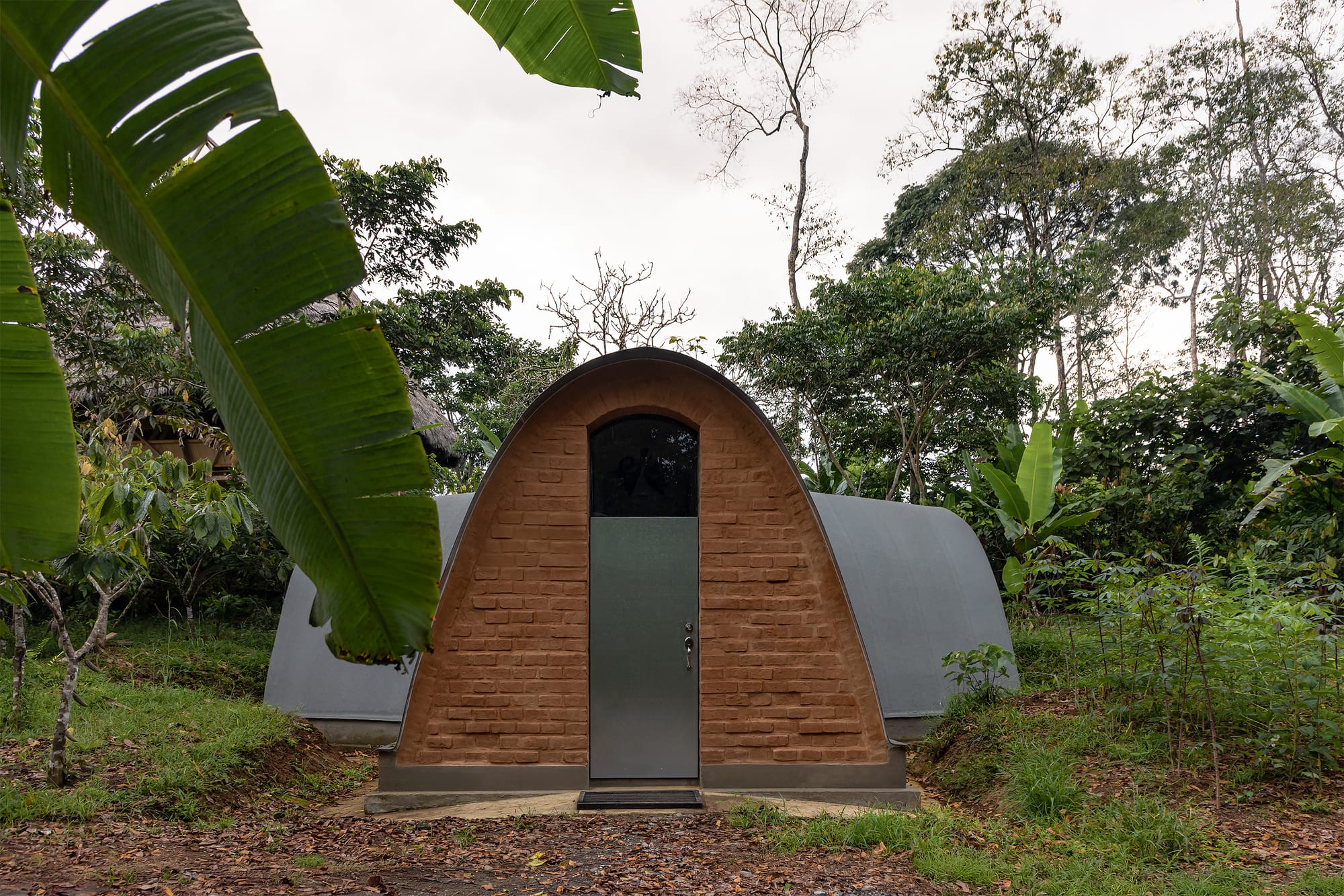 Outside view on jungle, brick constructed laboratory with three arches.