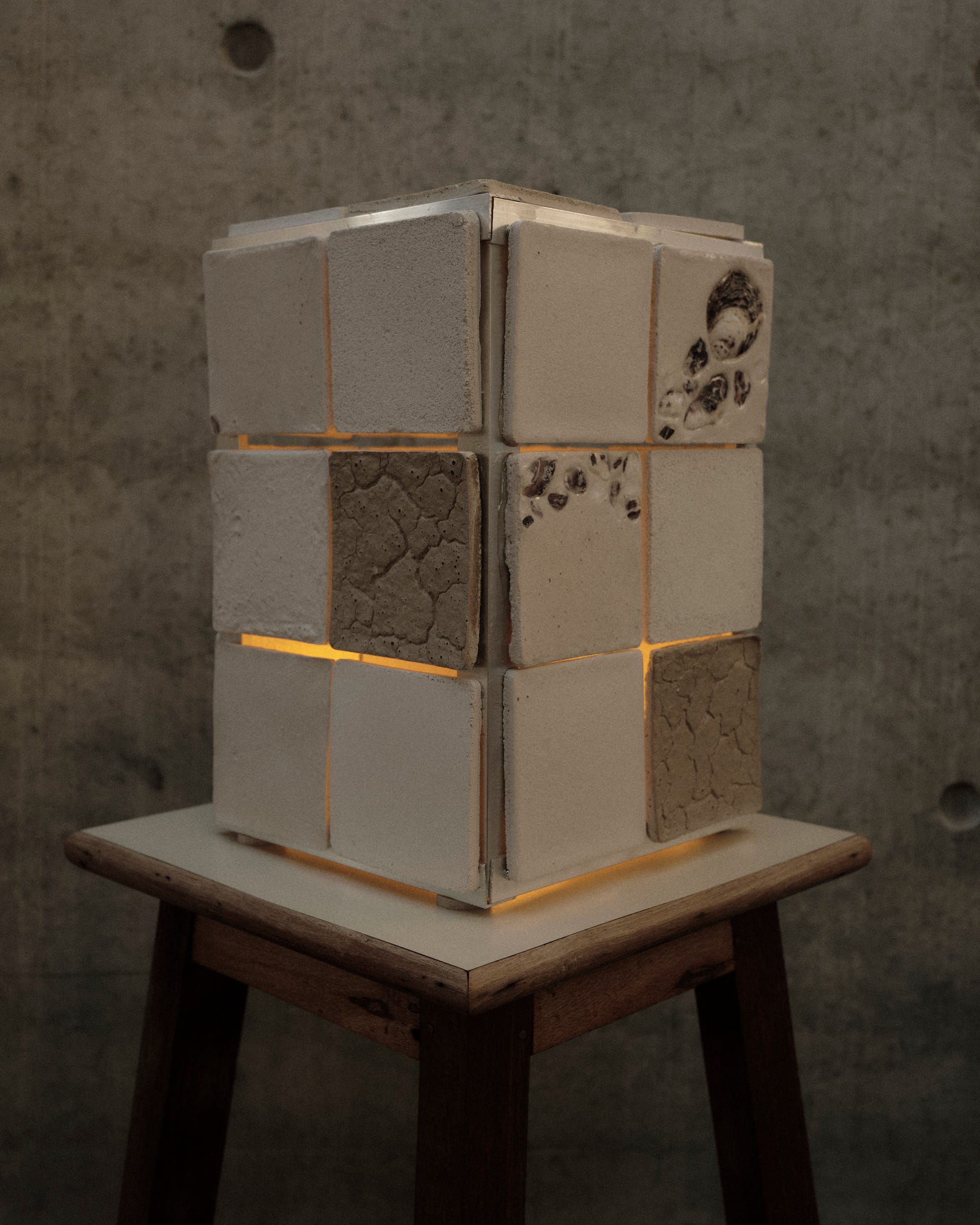Off white lamp made of bio ceramic oyster shell tiles.