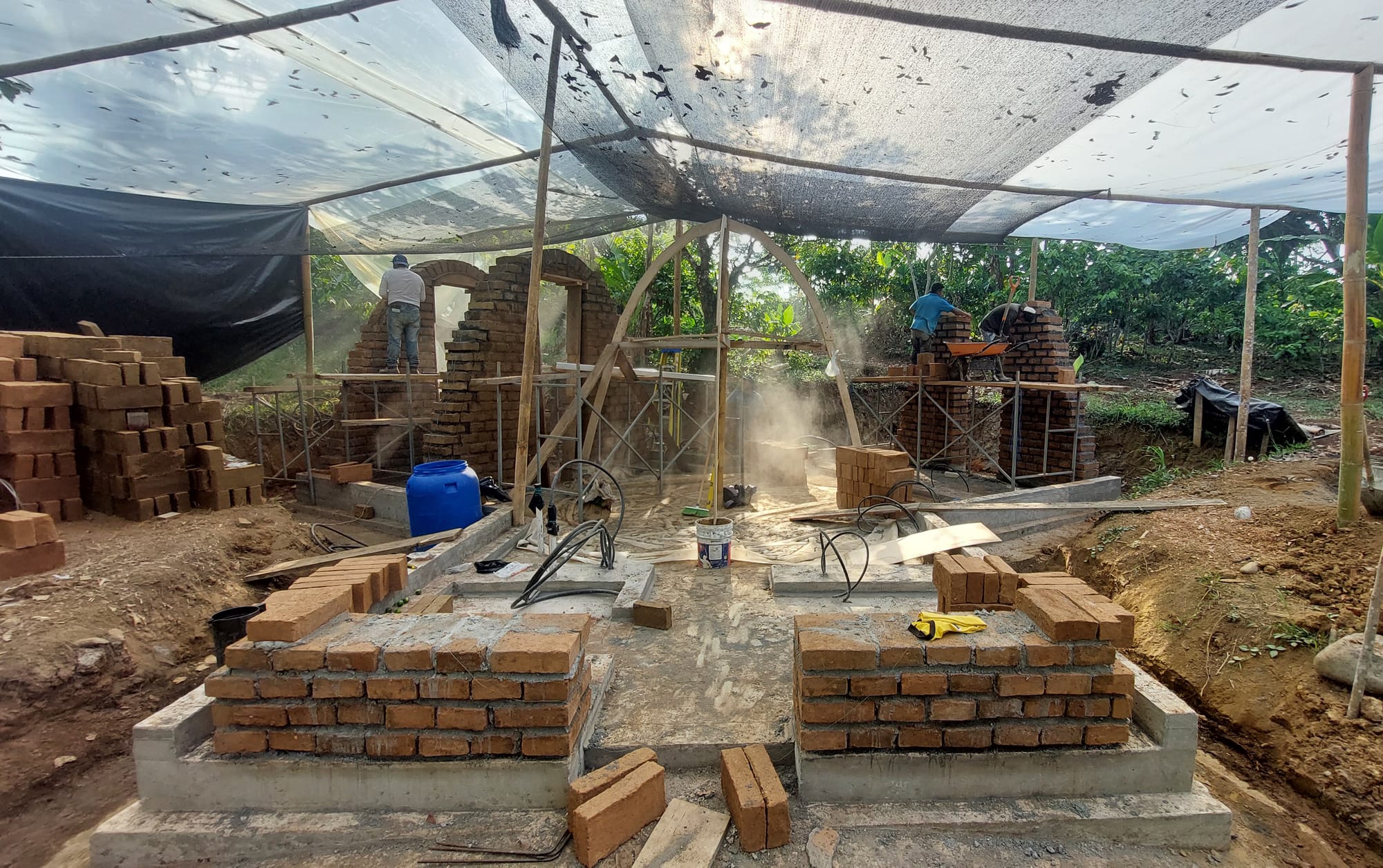 Construction site with arches and bricks.