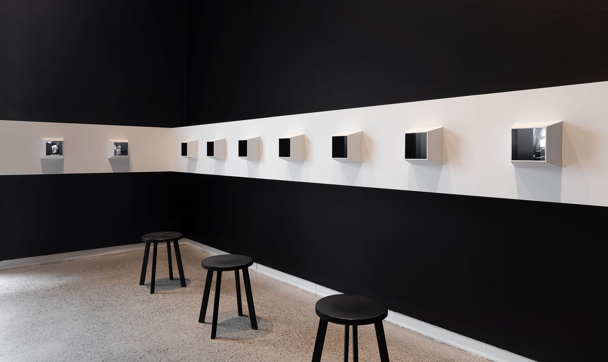 Exhibition design boxes showcasing photographs.