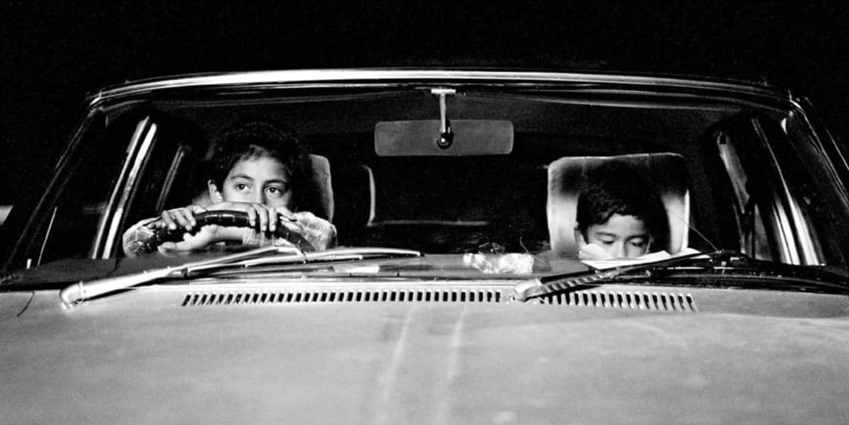 a still of two kids sitting in a car, from Taika Waititi's Two Cars, One Night