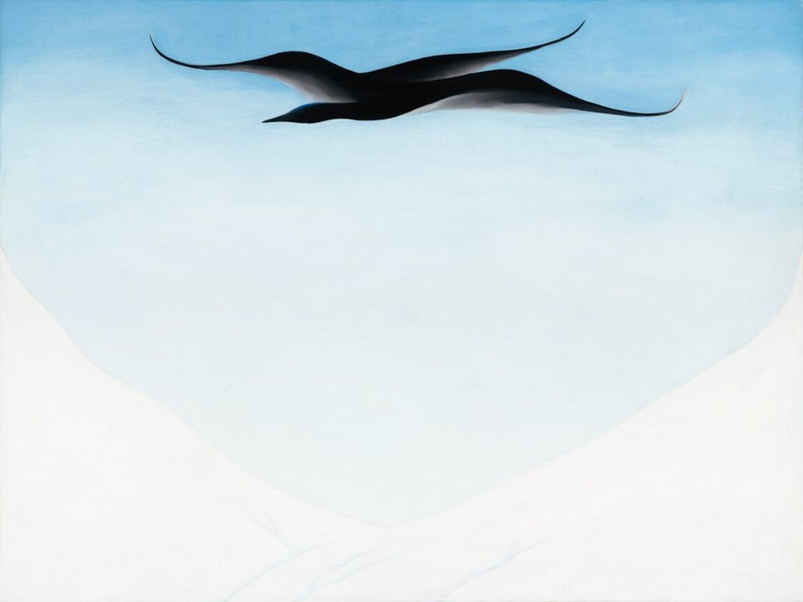 At the top of this painting is a smooth, dark shape resembling a bird in flight. The bird is made of long, curved lines, with its wings extended to either side and its head pointing to the left. The background of the painting is a blue gradient, transitioning from a medium blue at the top to a very light, almost-white shade of blue in the middle of the painting. The very bottom of the painting is completely white and forms a U-shaped valley below the bird.