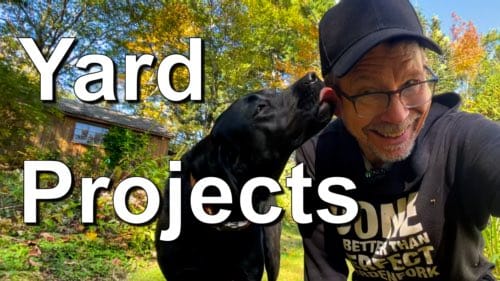 dog licking man's face in yard