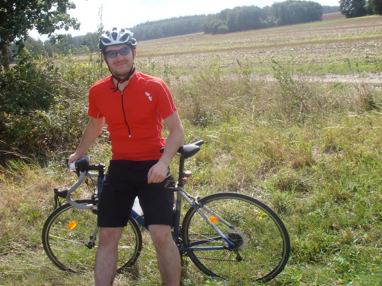 A young Iain leaning on a cheap road bike in front of a field somewhere in Europe