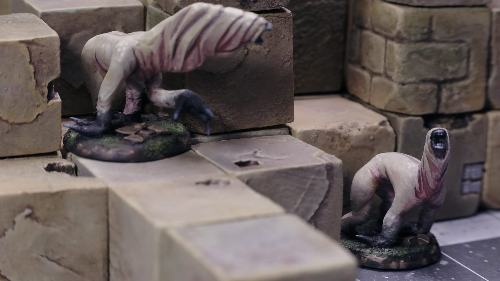 Two monster models mixed in among terrain cubes.