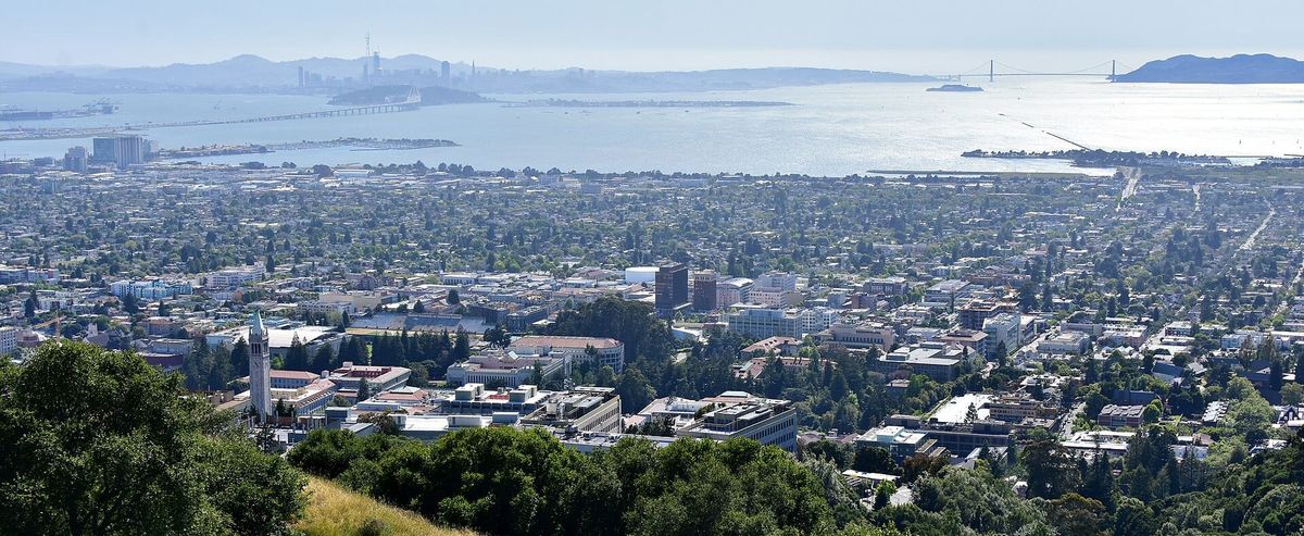 View from the hills above Berkeley CA. Campus, downtown, tree-lined residential neighborhoods, water, SF skyline and bridges