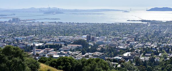 View from the hills above Berkeley CA. Campus, downtown, tree-lined residential neighborhoods, water, SF skyline and bridges