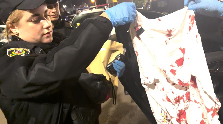 Image showing a Ukrainian police officer holding a bloodied cloth