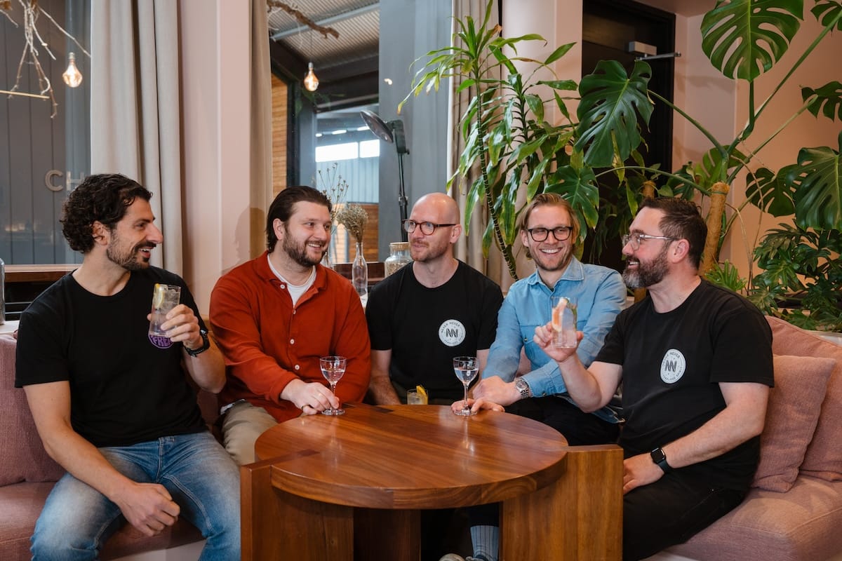 Cameron Parish (in red) and Lachlan Bentley (blue) with the Never Never Distilling Co. team talking Martinis. Photo: Supplied