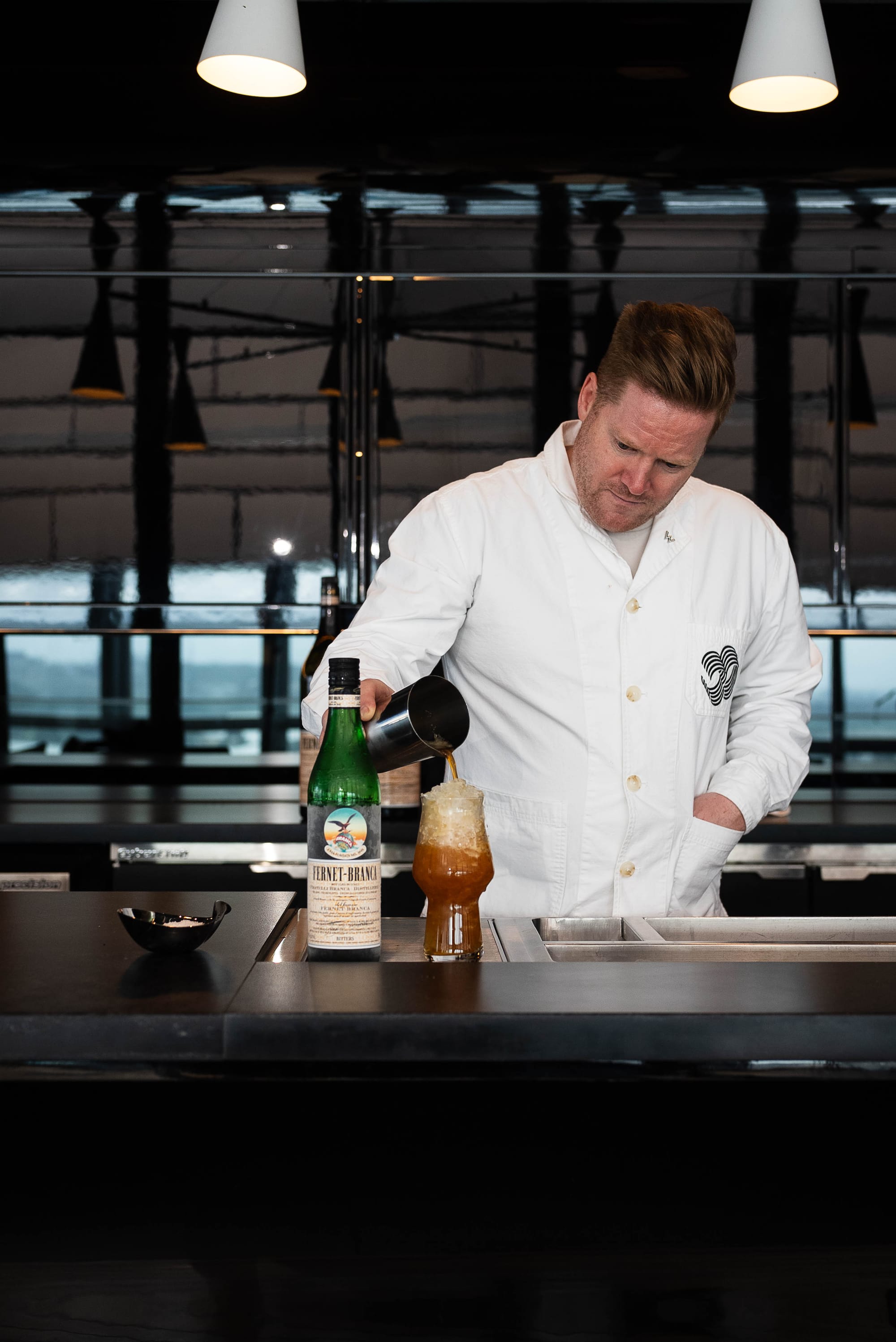 Barney Toy pours his Fernet Con Cola at Level 30 in W Sydney. Photo: Boothby
