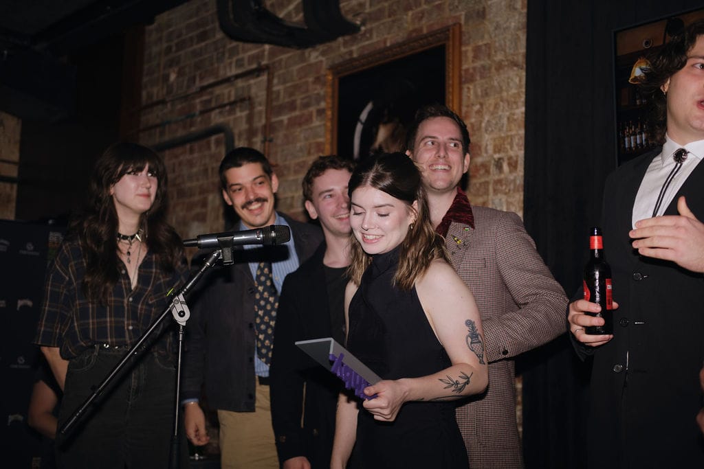 Corby Small accepts the trophy on behalf of The Gresham. Photo: Mikayla Adams