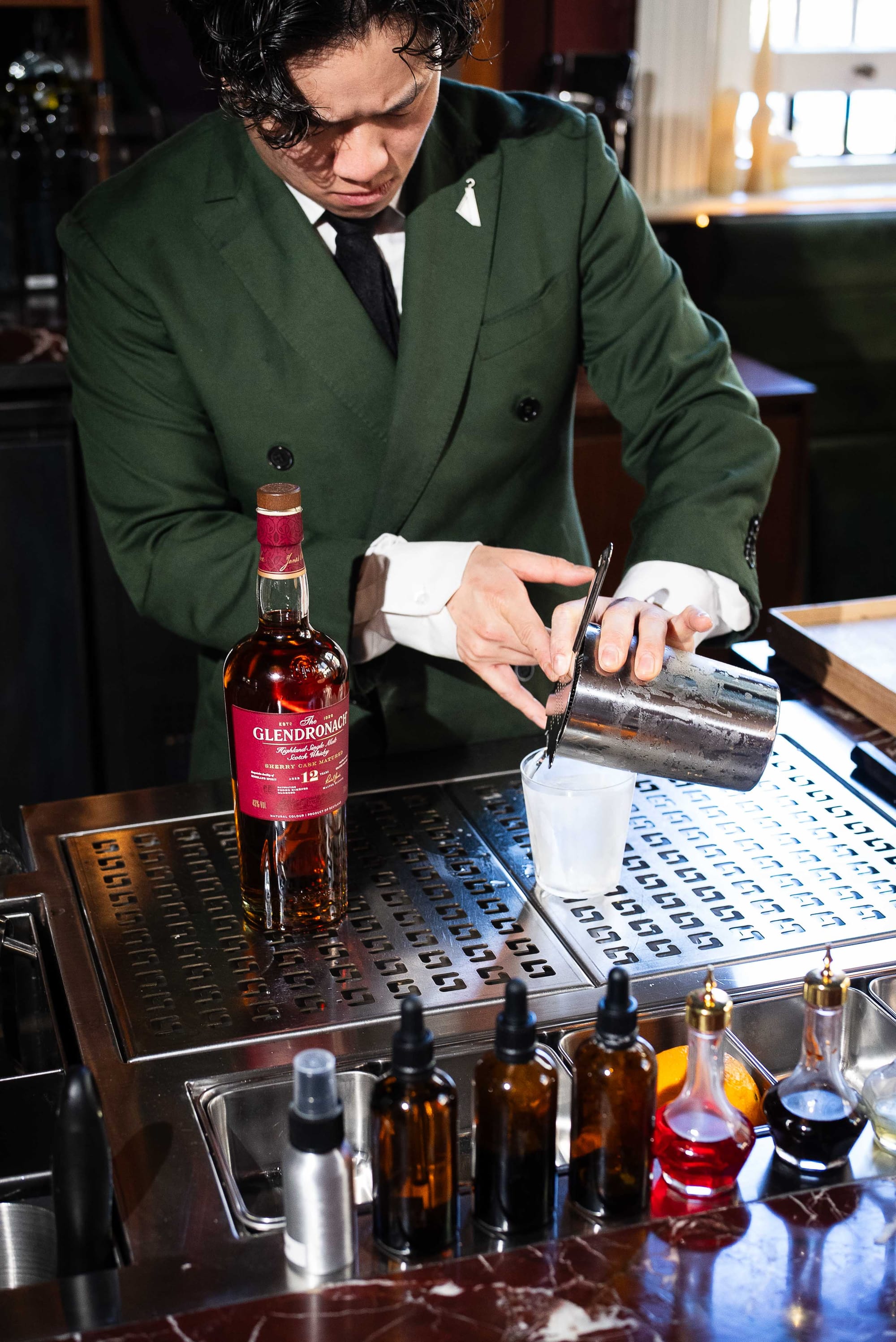 Tailor Room bar manager Benji Kinoial pours the Paisley. Photo: Boothby