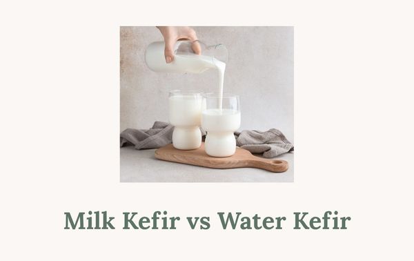 Close-up of milk being poured into glasses placed on a wooden kitchen board