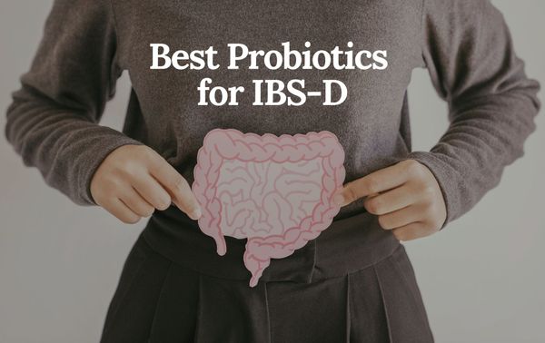 Cropped view of a woman's torso holding a drawing of the digestive tract over her stomach area