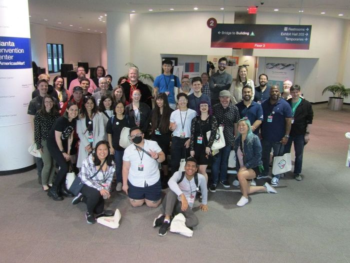 A large group of Ruby community members posing together at a conference
