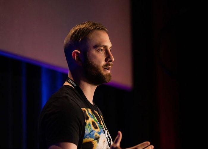 A speaker presenting on stage at a Ruby conference
