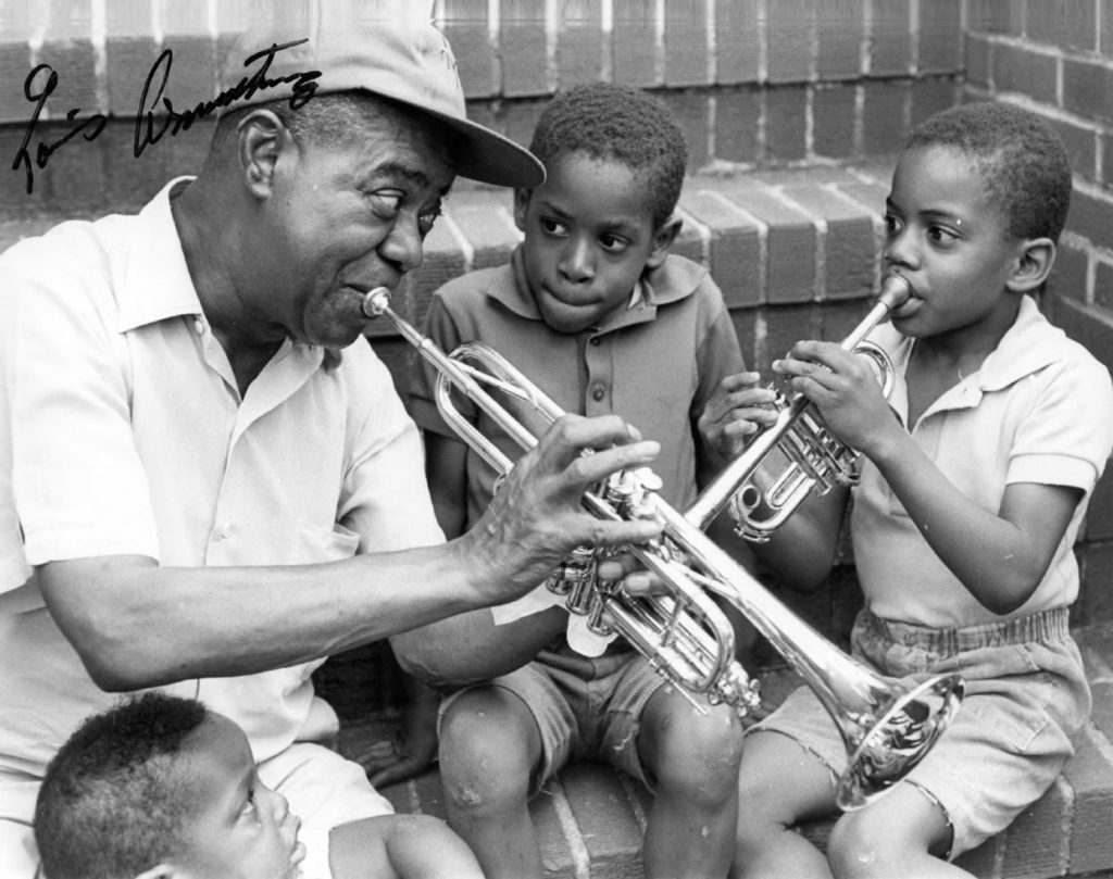 Louis Armstrong plays music on steps with children