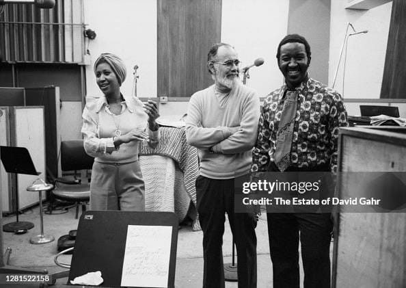 NEW YORK - JANUARY 11: ( L-R) American soul and gospel singer songwriter, pianist, and civil rights activist Aretha Franklin (Aretha Louise Franklin - March 25, 1942 - August 16, 2018), record producer Jerry Wexler, and legendary session drummer Bernard Purdie pose for a portrait during a recording session for Aretha at Atlantic Records' recording studios on January 11, 1974 in New York City, New York. (Photo by David Gahr/Getty Images)