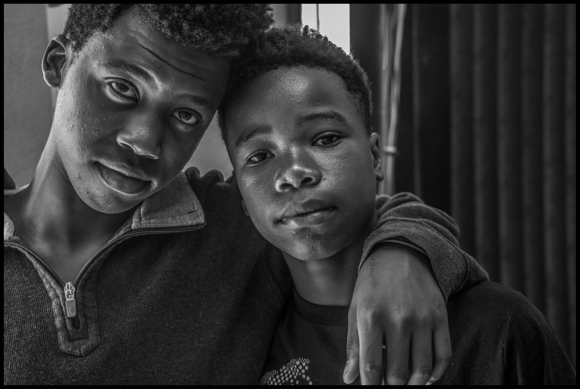 Clyson Jeanlaurent and his brother Manielsonluc Jeanlaurent at the YMCA shelter in Tijuana, which houses unaccompanied young people from other countries or parts of Mexico where people have fled violence or poverty. They came from Haiti two years ago and hope to join their family in Texas. All photos © David Bacon.